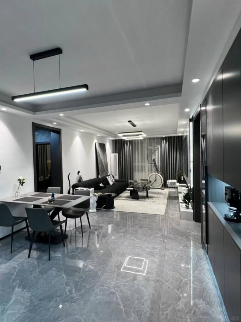 Polished grey marble-effect flooring in a modern living and dining room interior.