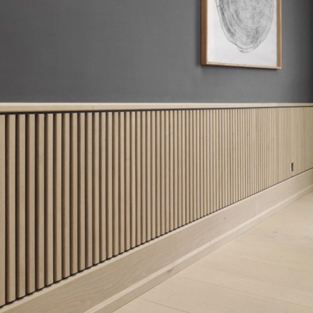 Vertical light wood slats covering the lower half of a dark grey interior wall.