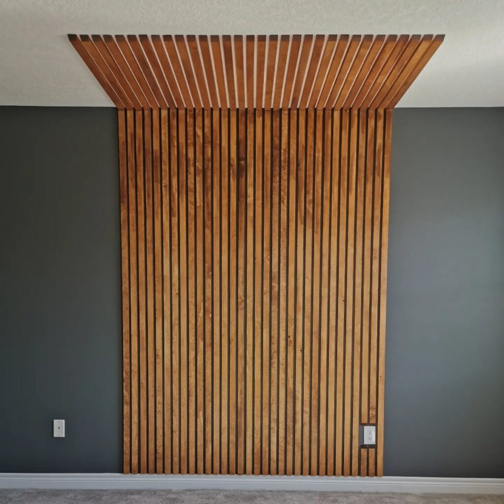 Vertical wooden slats create a textured accent wall and ceiling feature on a grey wall.