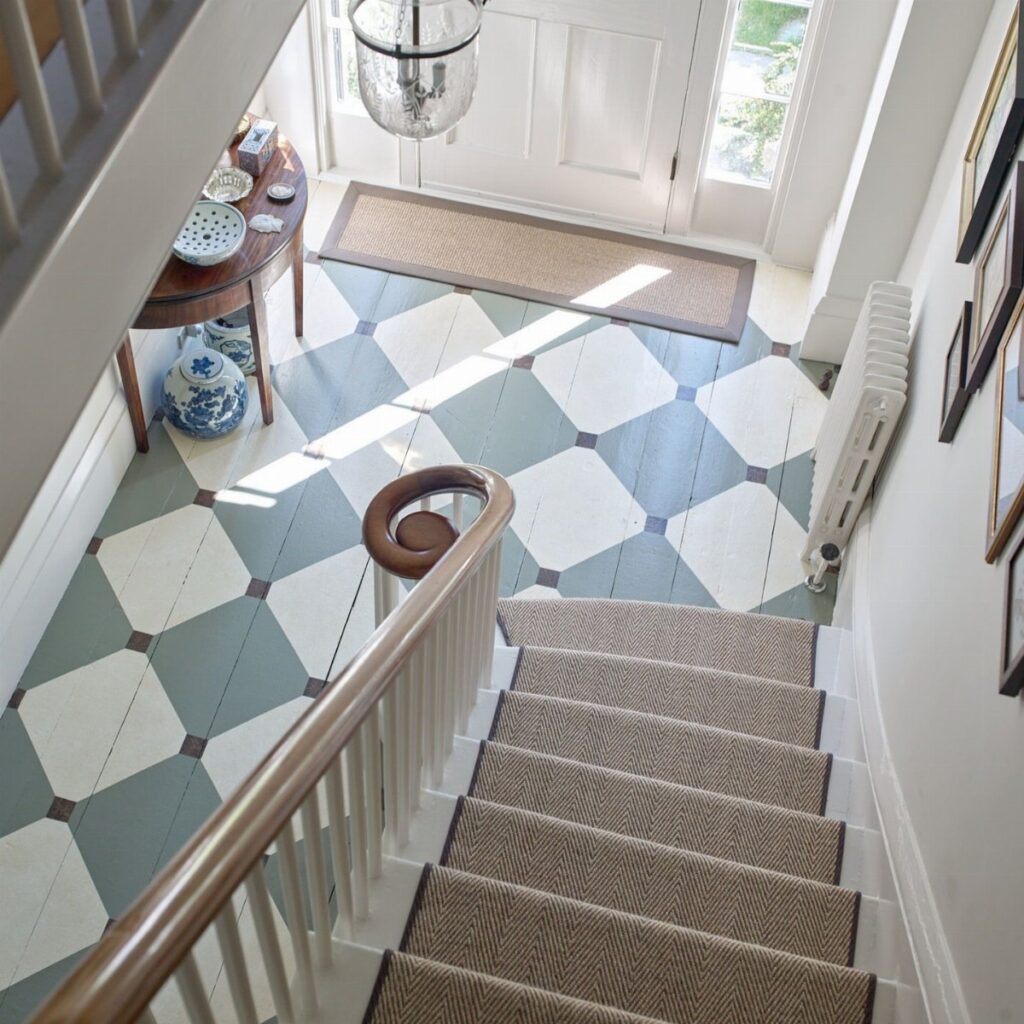 A checkerboard patterned floor in white and blue-grey tiles located in an entryway.