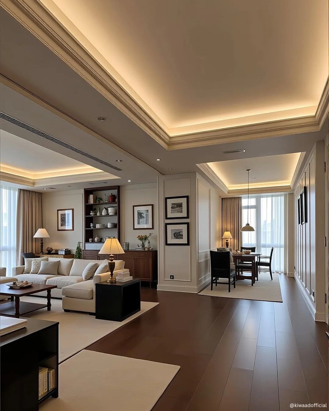 Dark wood floors stretching through a modern, brightly lit living and dining room area.